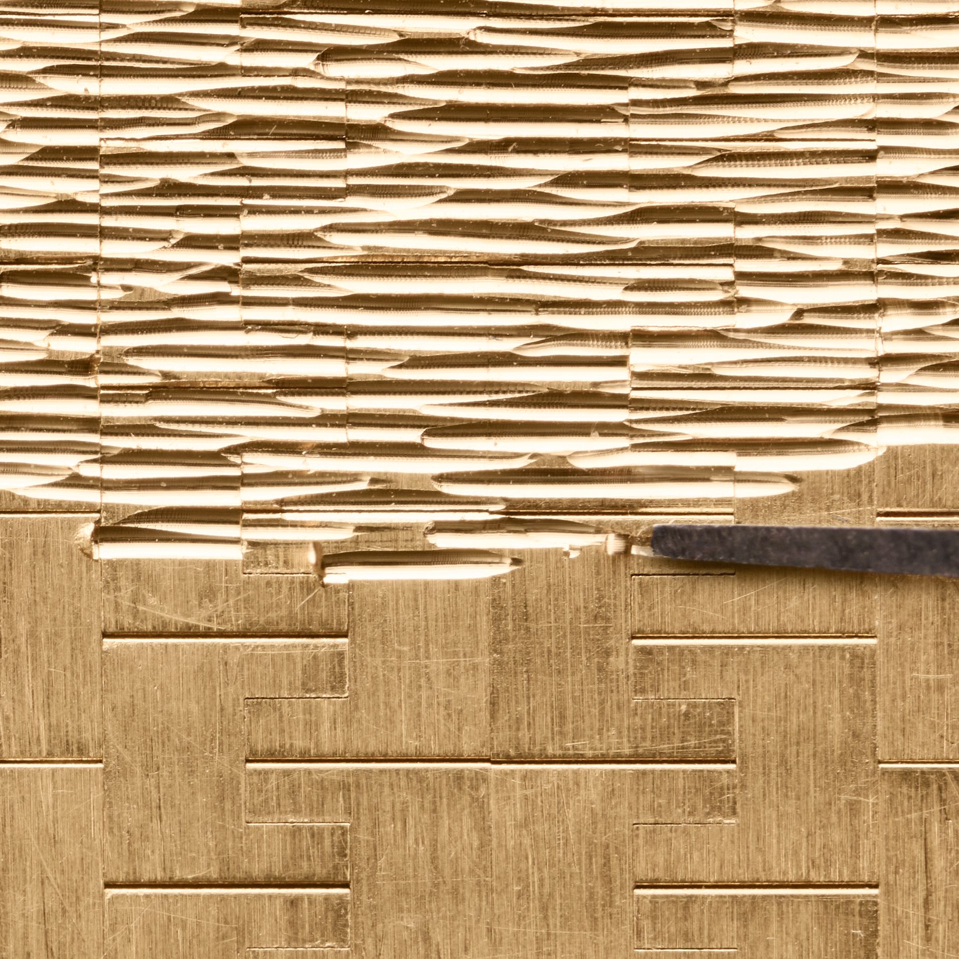 Detail of Piaget Limelight Gala engraved gold bracelet inspired by snake-skin texture