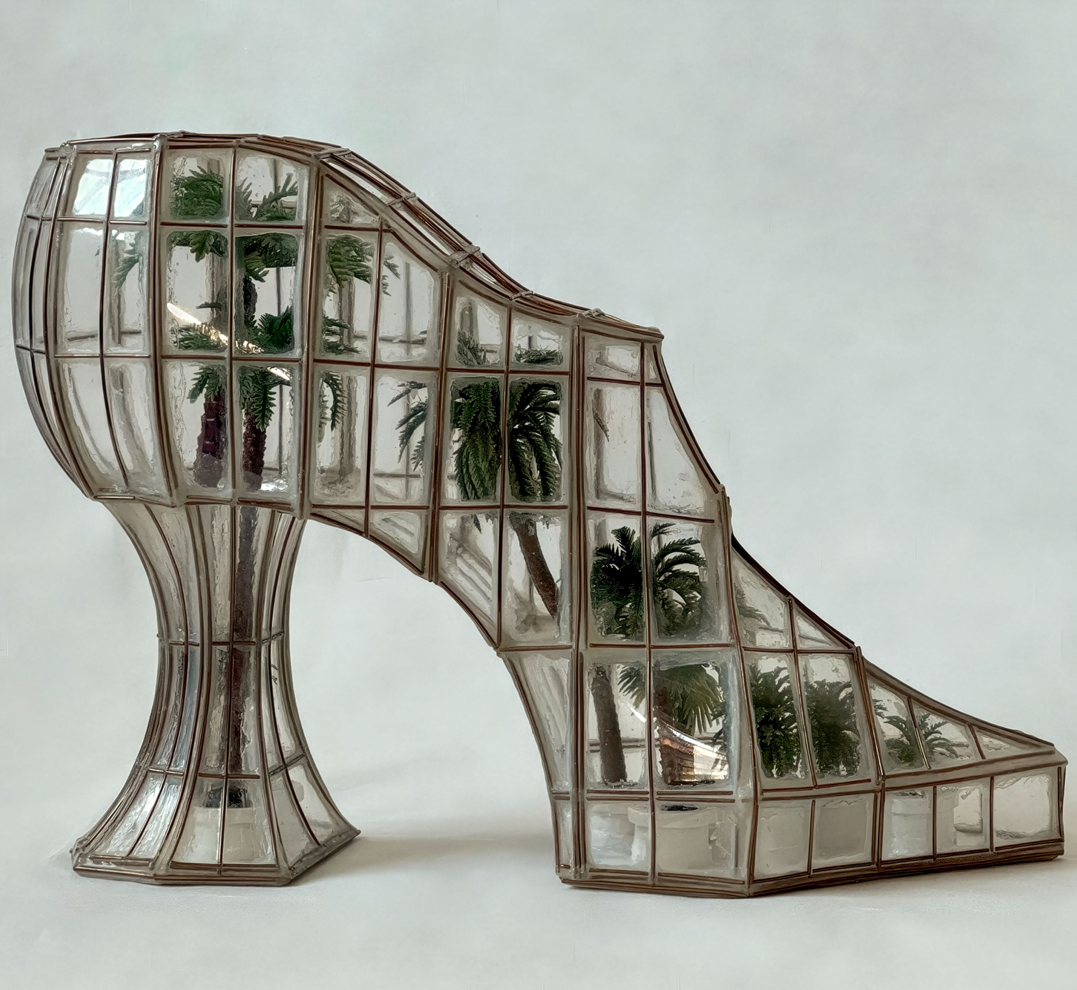 Palm House Pantoufle, 2022, acid-free paper and cardboard, brass wire, recycled plastic containers, pH-neutral archival adhesive, acrylic paint, miniature plastic palms, black Swarovski crystals. 10 x 4 x 7.5 inches / 26 x 11 x 20 cm.