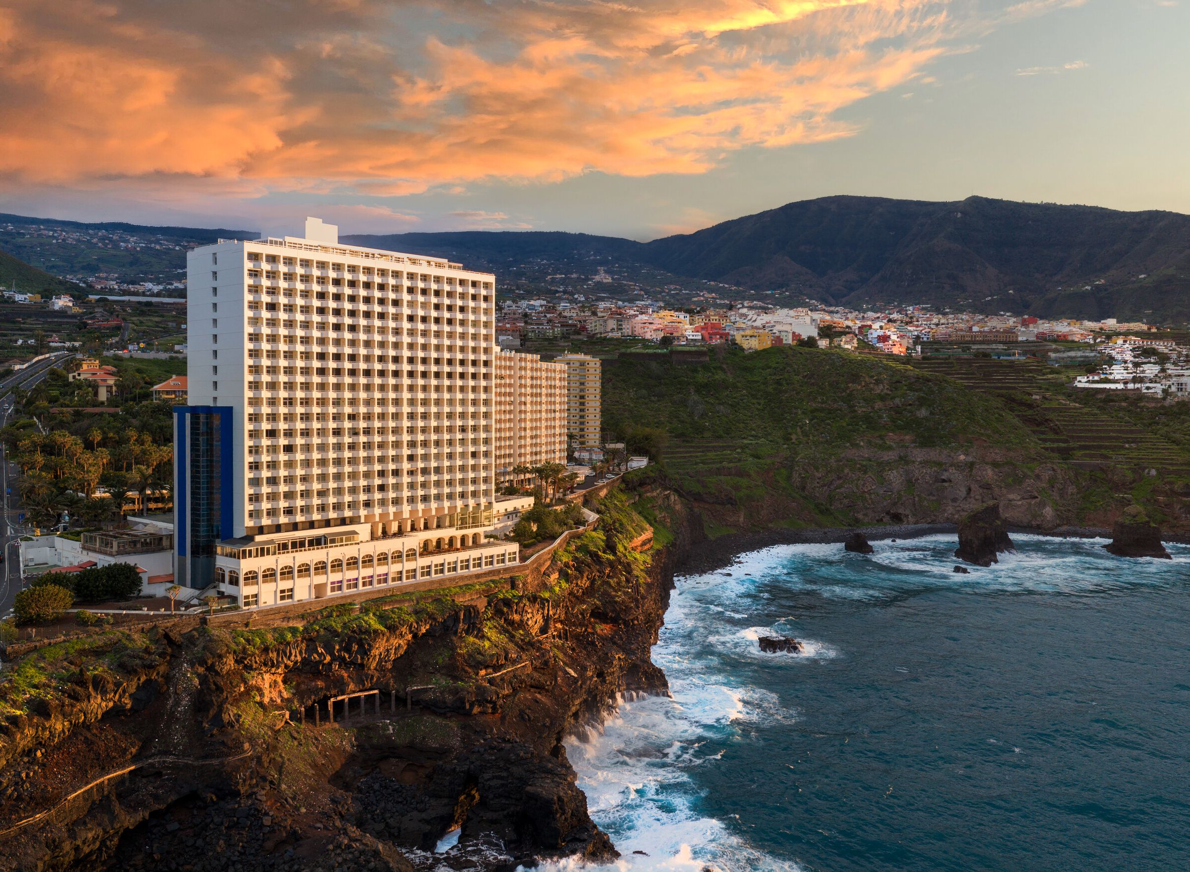 The vertical silhouette of Precise Resort Tenerife rises above the northern Tenerife coastline, a landmark originally built in the late 1970s