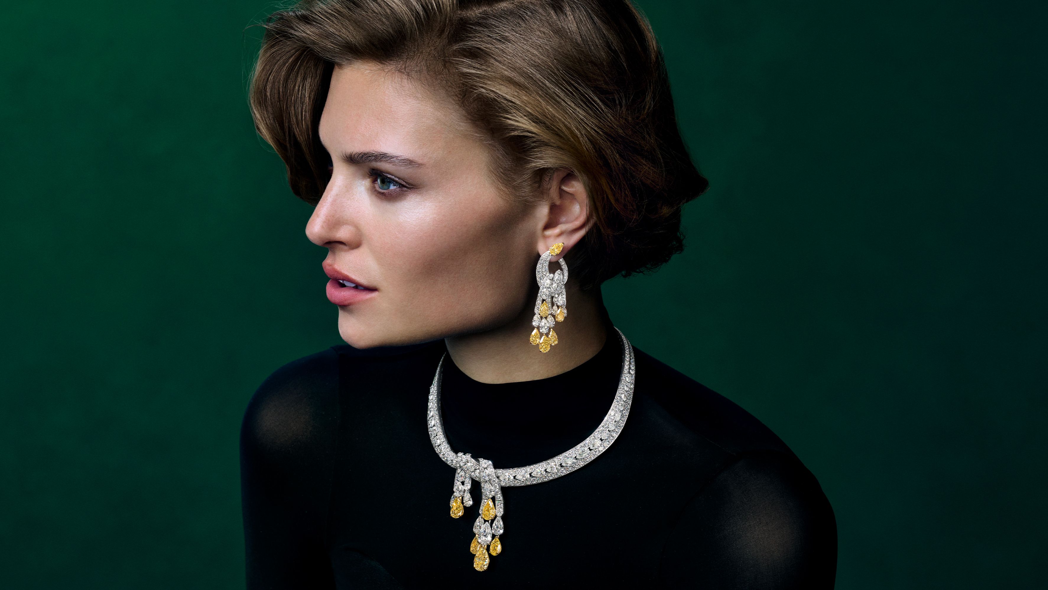A Graff High Jewelry necklace and matching earrings are centered on a series of pear-shaped Fancy Yellow diamonds.