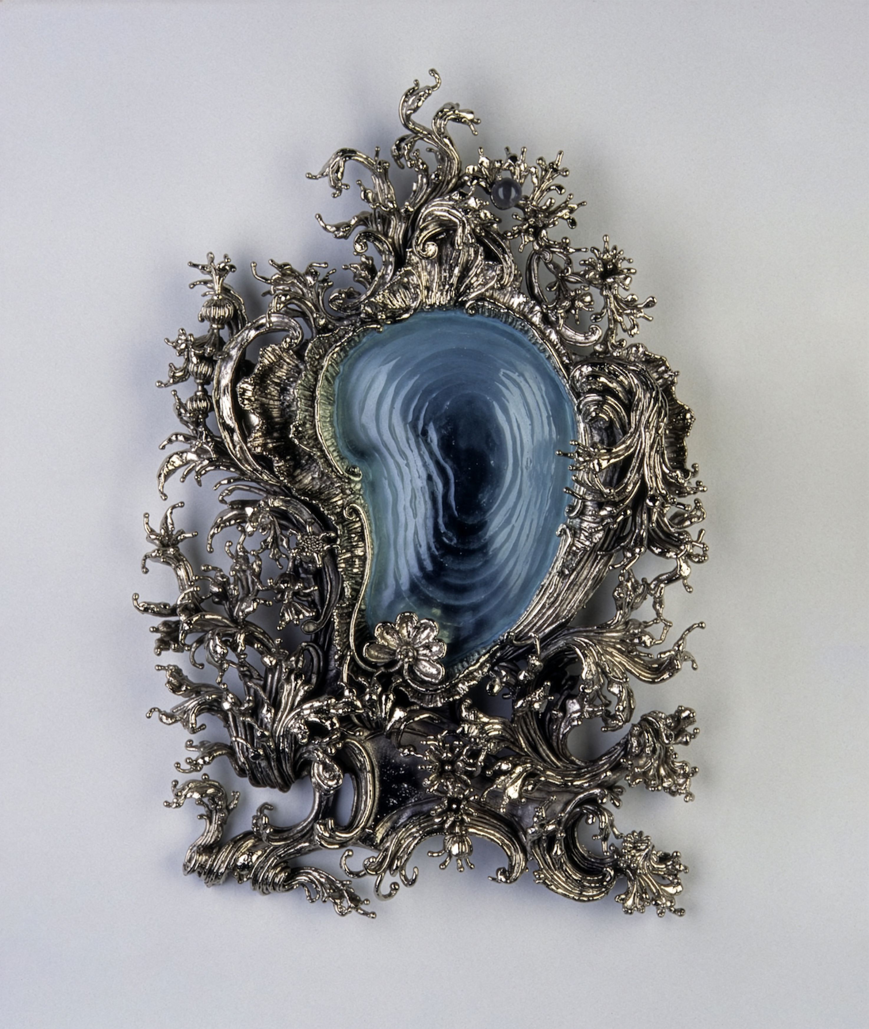 Bearded Clam, 1998. Nickel-plated bronze. Kiln-formed glass. 30 x 21 x 4 inches / 75 x 55 x 10 cm. Private collection, Paris, France. "This piece was made as a one-off commission. My current work revisits an ongoing fascination with Rococo cartouche and mirror frames."