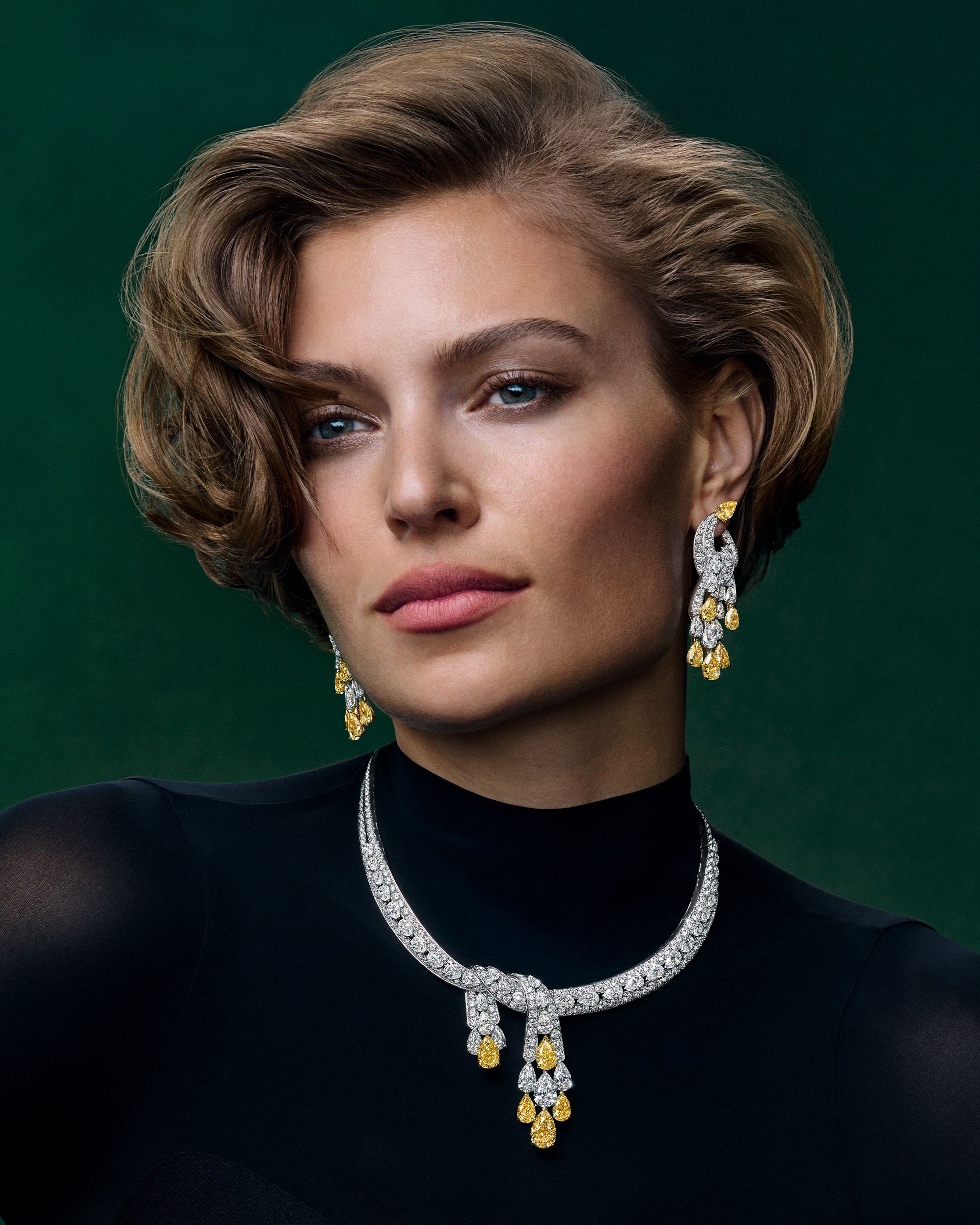 A Graff High Jewelry necklace and matching earrings are centered on a series of pear-shaped Fancy Yellow diamonds.
