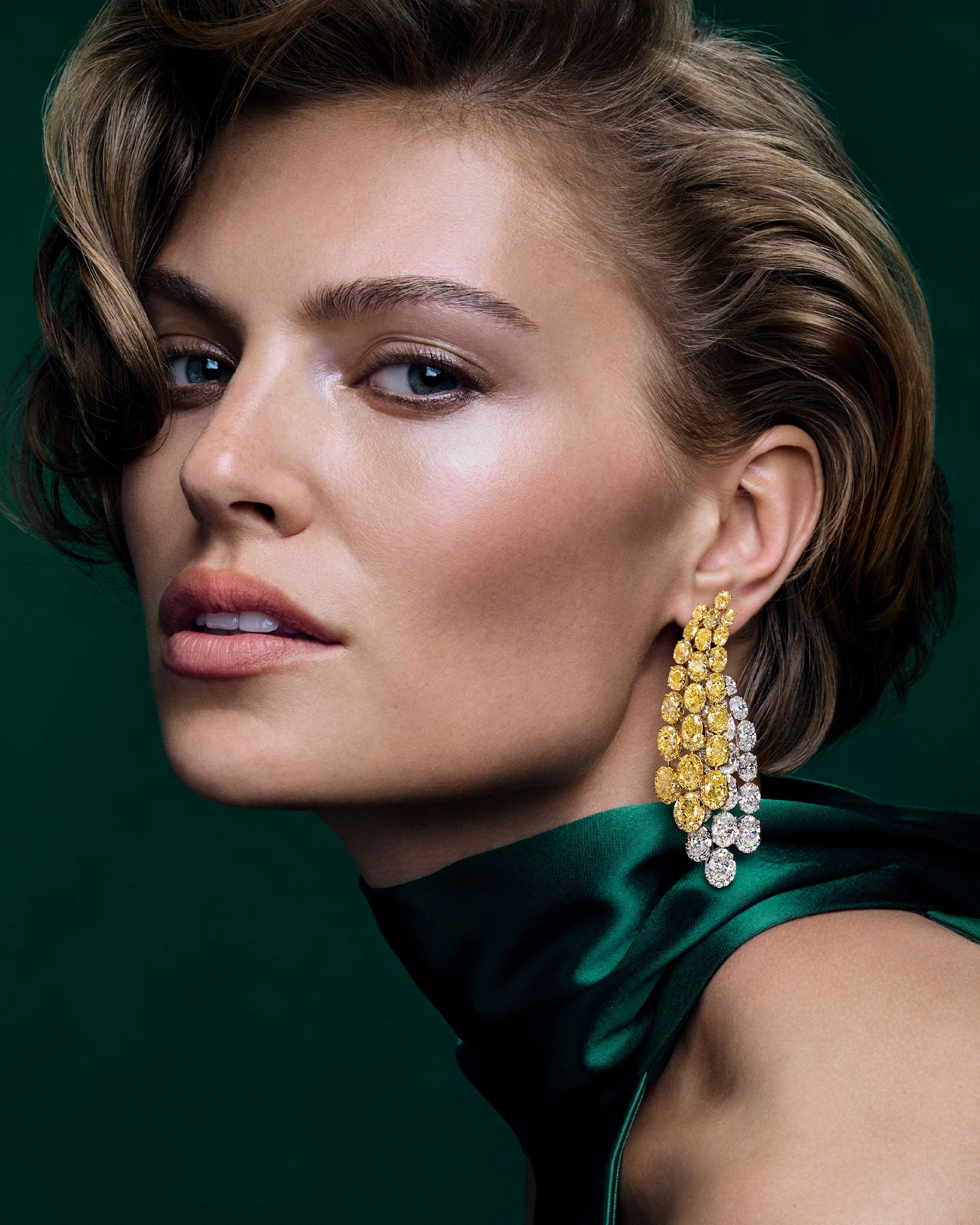 A pair of Graff High Jewelry earrings showcases more than 65 carats of oval Fancy Yellow and white diamonds, arranged in cascading lines.
